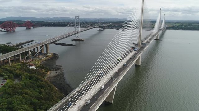 Tilting drone shot of Queensferry Crossing bridge near Edinburgh, transportation and infrastructure in Scotland, United Kingdom