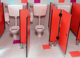 small toilets with red doors for children in a kindergarten