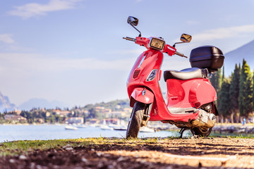 Beautiful red scooter on the beach, landscape and blue sky