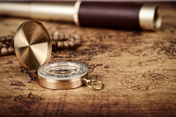 Vintage compass and spyglass telescope  on old map  - Explorer  concept