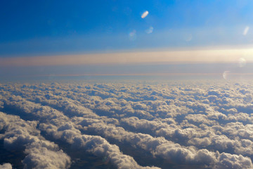 Fototapeta na wymiar sky with fluffy clouds, the view from the plane, flying on an airplane
