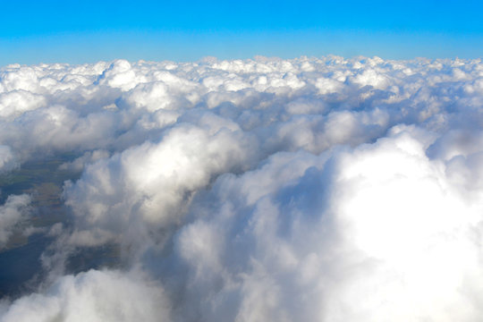 sky with fluffy clouds, the view from the plane, flying on an airplane © assoli