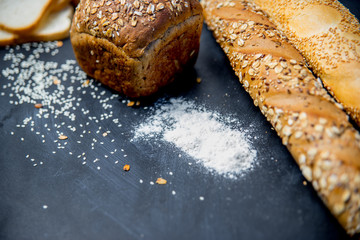 assorted fragrant loaves of bread with flour