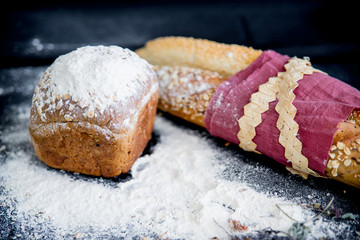 assorted fragrant loaves of bread with flour