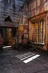 Ancient sandstone sanctuary with window light and shadow