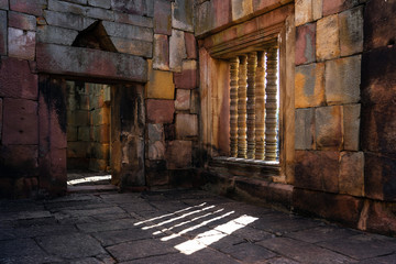 Ancient sandstone sanctuary with light through stone window
