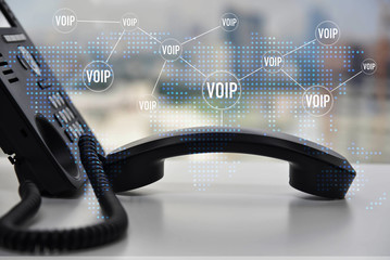 IP Phone double exposure with blue LED world map and business icon of VOIP for communication concept