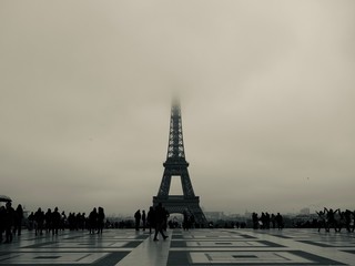A beautiful illuminated Eiffel Tower and misty night street in Paris, France - Image