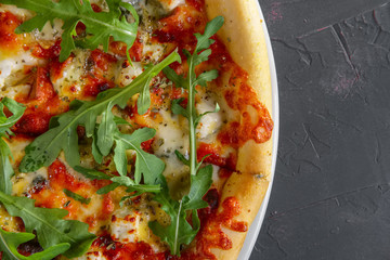 Vegetarian pizza with feta, arugula, mozzarella