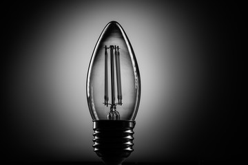 Silhouette led lamp against on a black background
