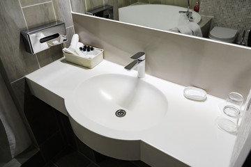 Fototapeta premium Bathroom interior with white sink and faucet