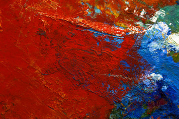 multi-colored strokes of oil paint on the artist's palette. background