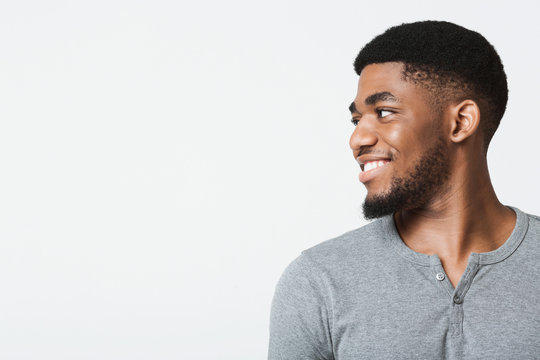 Half-turned smiling african-american man looking at copy space