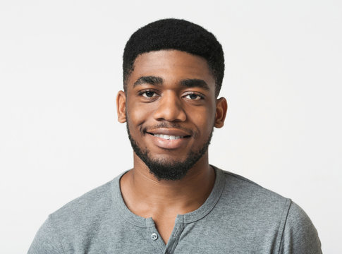 Young smiling african-american man over white background