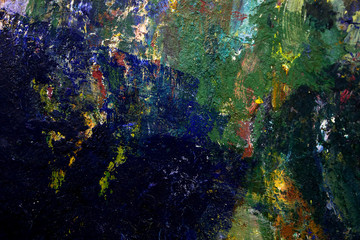 multi-colored strokes of oil paint on the artist's palette. background