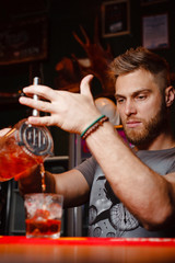 Brutal bartender pours Negroni cocktail