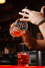 Brutal bartender pours Negroni cocktail