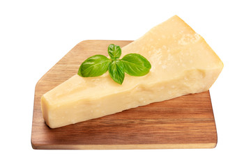 A piece of aged Parmesan cheese with fresh basil leaves, isolated with a cutting board on a white background with a clipping path