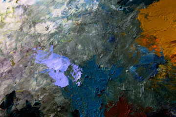 multi-colored strokes of oil paint on the artist's palette. background