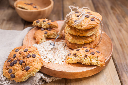 Biscuit biscuits with chocolate drops. Healthy homemade pastries. Photo in rustic style, food on wooden background. Free space for text.