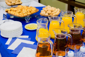 Orange and Apple juices in decanters, sweet pastries on the buffet.