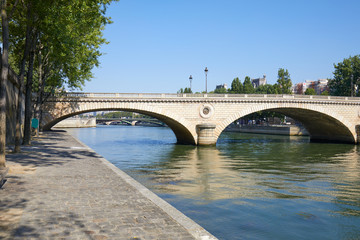 Paris, empty Seine river docks and bridge in a sunny summer day in France
