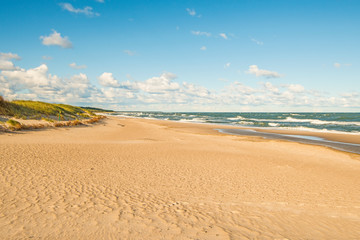 beach of the Baltic Sea with blue sky and clouds