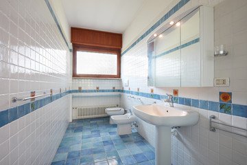 Normal bathroom with blue and white tiles in apartment interior