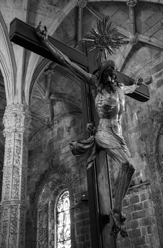 Crucifix.  Jeronimos Monastery in Lisbon, Portugal. This monastery is one of the most prominent examples of the Portuguese Gothic Manueline style. Black white photo.