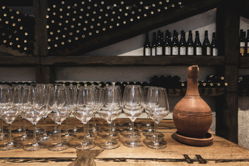 Wine glasses with an earthenware jug in the wine cellar