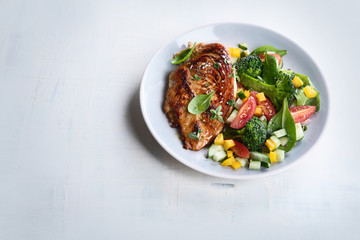 Chicken breast with fresh vegetable salad