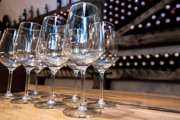 Row of empty wine glasses in a wine cellar
