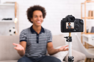 Happy video blogger on screen of modern camera