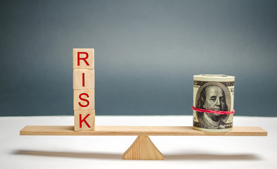 Dollars and the inscription Risk on the scales. The concept of financial risk and investing in a...