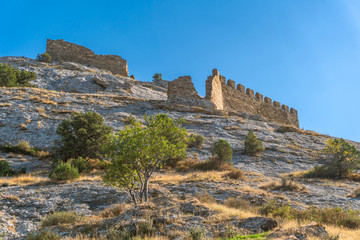 Ruins of the Genoese fortress in Sudak, Crimea against the blue sky.