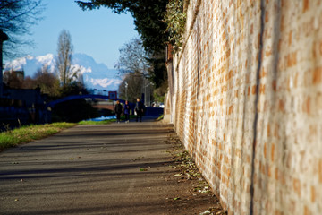 Milan, Italy, 12.12.2018: Jogging track for exercise at the plubbic park, Green garden park and road in moring