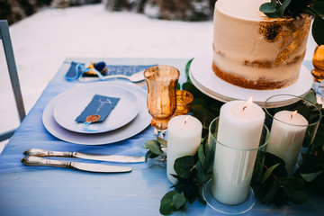 A beautiful cake on a elegant table with serving