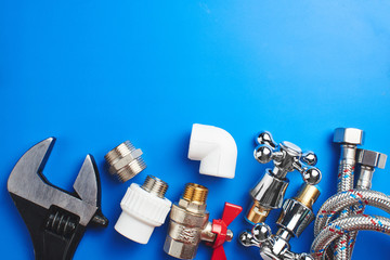 plumbing tools and equipment on blue background with copy space