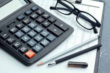 Business still life with calculator on table in office.