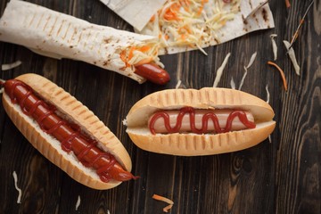 fast food.sausage in pita bread and hot dog on wooden background