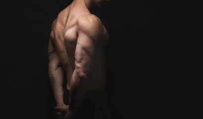 Unrecognizable man shows strong back muscles closeup