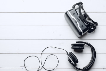 Stylish headphones and VR headset on the table