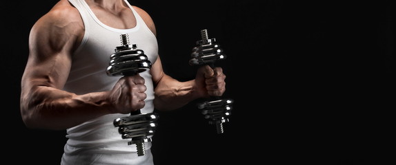 Fototapeta premium Strong athletic man with dumbbell showes muscular body