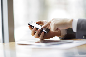 Fototapeta premium close up.businessman is typing SMS on a smartphone