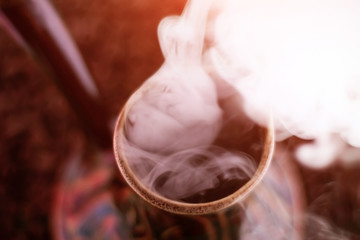 Boiling coffee in a copper pot for brewing coffee