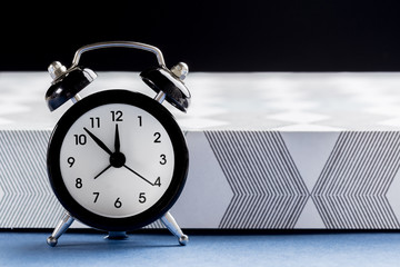 Vintage background with retro alarm clock on table
