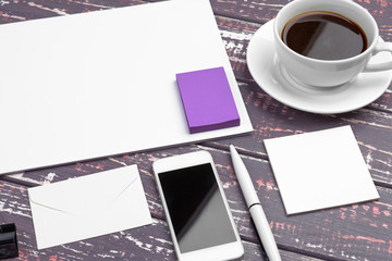 Branding stationery mockup on purple desk. Top view of paper,  business card, pad, pens and coffee.