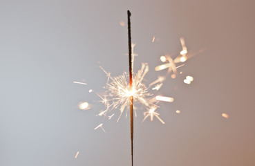 New Year's sparkler on a white background. Celebration