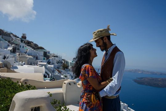young couple honeymoon on the most romantic island Santorini, Greece. Sunset in the city Oia