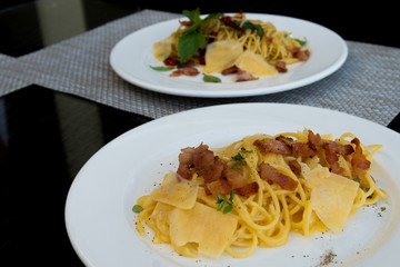 Homemade Hot Spicy Beacon spaghetti ham and cheese, Fusion food stylish arrange on glass table along ocean mangrove tree Island, empty copy space for text logo Yummy